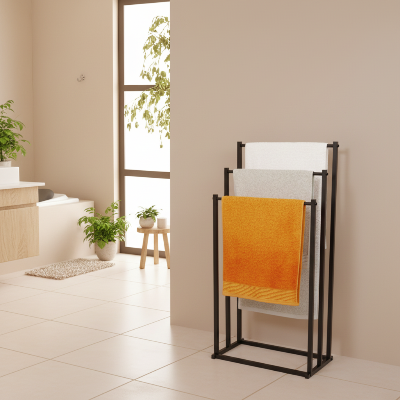 3 serviettes sur le porte serviette sur pied noir dans la salle de bain moderne