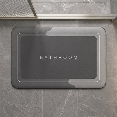 Tapis antidérapant salle de bain avec inscription bathroom dessus devant la douche
