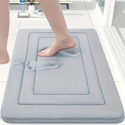 un pied sur tapis de salle de bain gris pale