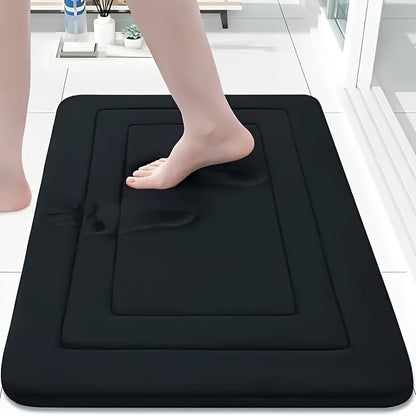 un pied sur tapis de salle de bain noir